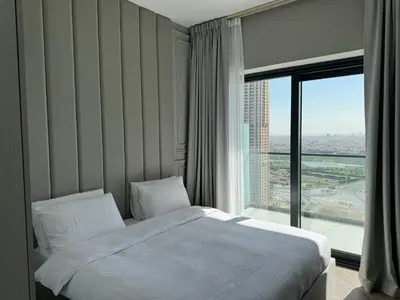 a hotel room with a bed and a large window at Zada Tower , near to Burj Khalifa NYE fireworks in Dubai
