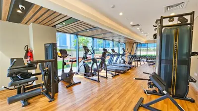 a gym with treadmills and elliptical machines at Zada Tower , near to Burj Khalifa NYE fireworks in Dubai