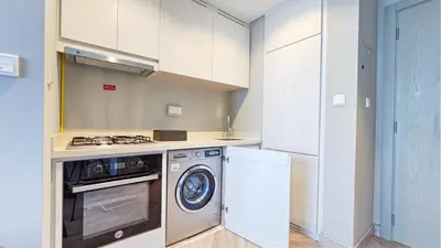 a kitchen with a washer and dryer in it at Zada Tower , near to Burj Khalifa NYE fireworks in Dubai