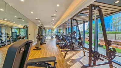 a gym with treadmills and elliptical machines at Zada Tower , near to Burj Khalifa NYE fireworks in Dubai