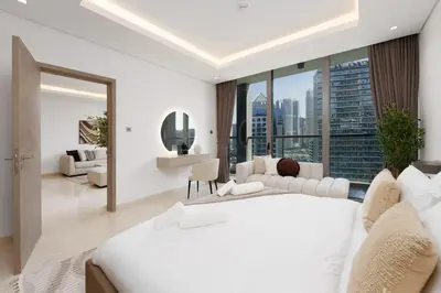 a bedroom with a large white bed and a large window at Business Bay Exquisite Living Experience-Suiteable in Dubai