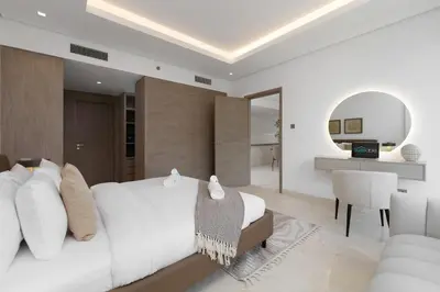 a bedroom with a white bed and a desk at Business Bay Exquisite Living Experience-Suiteable in Dubai