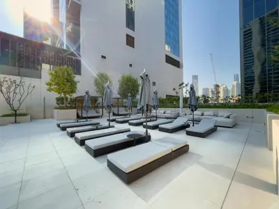 a patio with couches and umbrellas in a city at Business Bay Exquisite Living Experience-Suiteable in Dubai