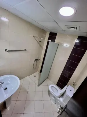 a bathroom with a toilet and a sink at Wonderful Partition Room in Al Barsha 1 Near Metro in Dubai