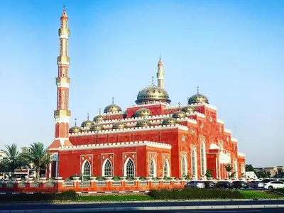 a large red building with domes and mosques at Wow Partition Room In Barsha 1 Near MOE Metro in Dubai