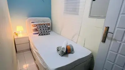 a small bed in a small room with a door at Wow Partition Room In Barsha 1 Near MOE Metro in Dubai