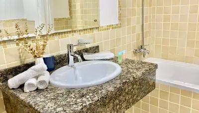 a bathroom counter with a sink and a bath tub at JBR Beach Full Sea View 2 BR High Floor in Dubai