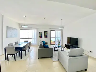 a living room with a table and a dining room at JBR Beach Full Sea View 2 BR High Floor in Dubai