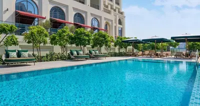 a swimming pool in front of a building at Luxury 1BR Retreat @ Vida Residences - Creek Beach in Dubai