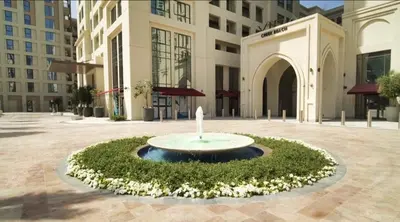 a fountain in the middle of a courtyard in front of a building at Luxury 1BR Retreat @ Vida Residences - Creek Beach in Dubai