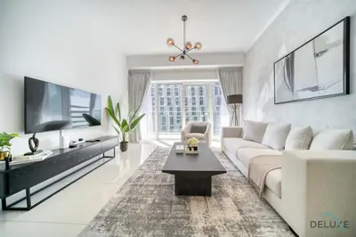a living room with a couch and a tv at Wondrous 1BR at DAMAC Heights Dubai Marina by Deluxe Holiday Homes in Dubai