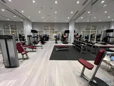 a gym with treadmills and chairs in a room at Wondrous 1BR at DAMAC Heights Dubai Marina by Deluxe Holiday Homes in Dubai