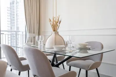 a dining room with a glass table and chairs at Elegant apartment in Dubai Creek Harbour in Dubai