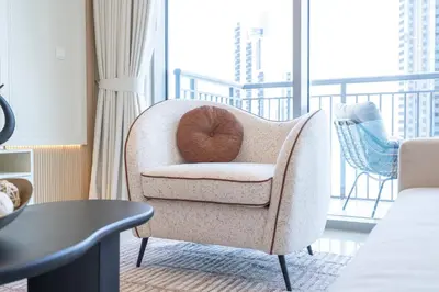 a kiwi sitting on a chair in a living room at Elegant apartment in Dubai Creek Harbour in Dubai