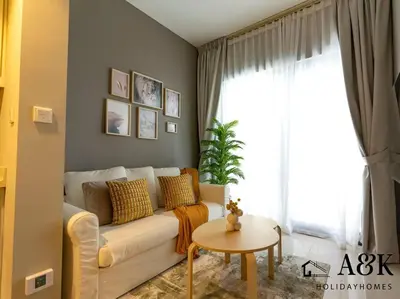 a living room with a white couch and a window at Near Burj Khalifa NYE Brand New Cozy 1BR Business Bay in Dubai