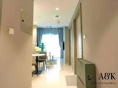 a hallway with a table and a dining room at Near Burj Khalifa NYE Brand New Cozy 1BR Business Bay in Dubai