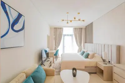 a bedroom with a bed and a couch at Studio with pool and private beach access on Palm Jumeirah in Dubai