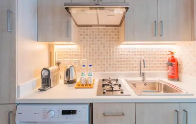a small kitchen with a sink and a stove at Studio with pool and private beach access on Palm Jumeirah in Dubai