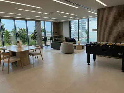 a lobby with a pool table and a living room at Bright New Studio with Pool & Gym Access, 5 min from Gardens Metro in Dubai