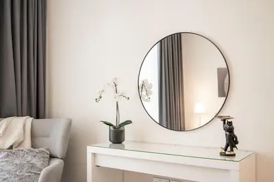 a living room with a mirror on the wall at Brand new 2 BR in Boulevard with partial Burj Khalifa and Opera View in Dubai