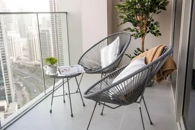 two chairs and a table in front of a window at Brand new 2 BR in Boulevard with partial Burj Khalifa and Opera View in Dubai