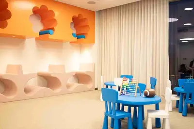 a room with blue chairs and a table and a painting at Brand new 2 BR in Boulevard with partial Burj Khalifa and Opera View in Dubai