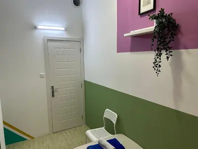 a room with a table and a chair and a door at Spacious Mini Partition Room Near Emirates Mall in Dubai