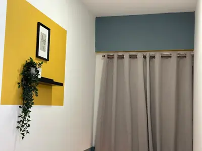 a room with a shower curtain and a window at Spacious Mini Partition Room Near Emirates Mall in Dubai
