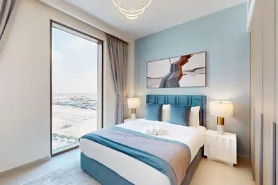 a bedroom with a large bed and a large window at Summer at Creek Beach - Elegant One Bedroom in Dubai