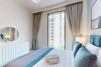 a bedroom with a bed and a large window at Summer at Creek Beach - Elegant One Bedroom in Dubai