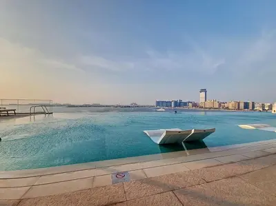 a swimming pool with a boat in the middle of a city at Beach Isle - Gorgeous One Bedroom in Dubai
