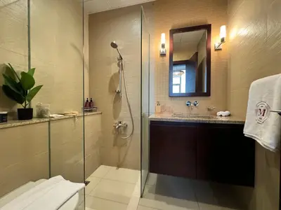 a bathroom with a shower and a sink at Manzil - 3BR in Palm Jumeirah with Private Beach Access & Sea View in Dubai