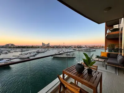a balcony with a view of a marina at Manzil - 3BR in Palm Jumeirah with Private Beach Access & Sea View in Dubai