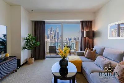 a living room with a couch and a large window at The Sophisticated Suite in Dubai