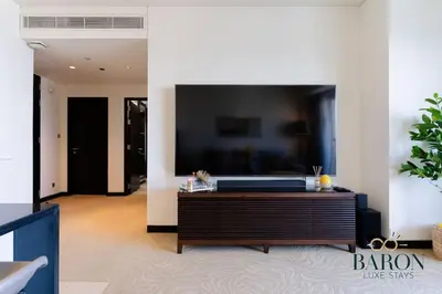 a living room with a large flat screen tv on a wall at The Sophisticated Suite in Dubai