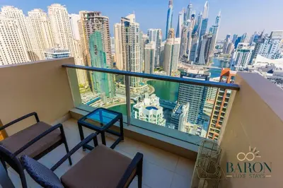 a balcony with chairs and a view of the city at The Sophisticated Suite in Dubai