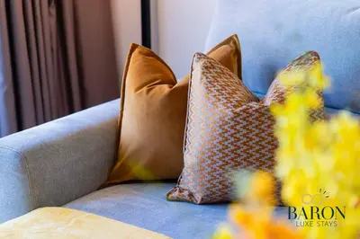 two pillows sitting on a blue couch at The Sophisticated Suite in Dubai