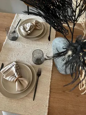 a table with two plates and a napkin and a tableablishthritisthritisthritis at SmartApt Elegant 1 BDR Burj view in Dubai