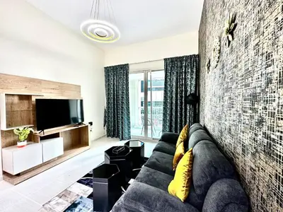 a living room with a couch and a tv at Elegant 2 BR in Dubai Marina walking Metro & Beach- Marina Park in Dubai