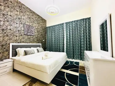 a bedroom with a large white bed and a bathroom at Elegant 2 BR in Dubai Marina walking Metro & Beach- Marina Park in Dubai