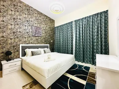a bedroom with a large white bed and a wall of bricks at Elegant 2 BR in Dubai Marina walking Metro & Beach- Marina Park in Dubai
