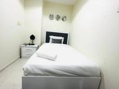 a small bedroom with a white bed and a nightstand at Elegant 2 BR in Dubai Marina walking Metro & Beach- Marina Park in Dubai