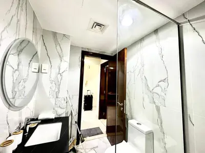 a bathroom with marble walls and a mirror at Elegant 2 BR in Dubai Marina walking Metro & Beach- Marina Park in Dubai