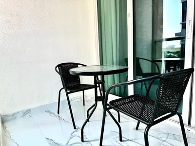 two chairs and a table on a balcony at Elegant 2 BR in Dubai Marina walking Metro & Beach- Marina Park in Dubai