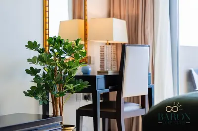 a room with a desk with a chair and a mirror at The Stylish in Dubai