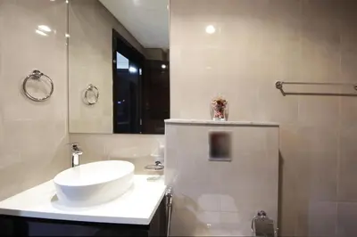 a bathroom with a white sink and a mirror at Studio Apartment in Merano Tower by The S Holiday Homes in Dubai