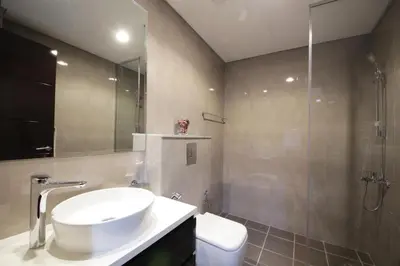 a bathroom with a sink and a shower and a toilet at Studio Apartment in Merano Tower by The S Holiday Homes in Dubai