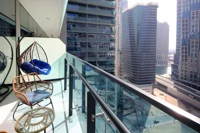 a balcony with two chairs and a view of a city at Studio Apartment in Merano Tower by The S Holiday Homes in Dubai