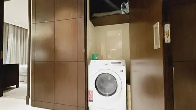 a laundry room with a washing machine in a room at Address Fountain View Tower 2 in Dubai