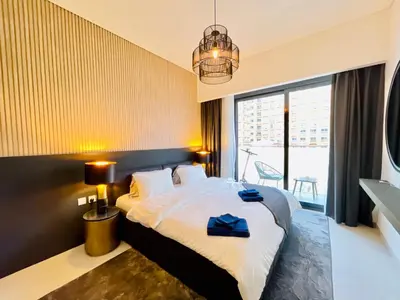 a hotel room with a bed and a large window at Luxury 1 Bedroom Apartment in Dubai